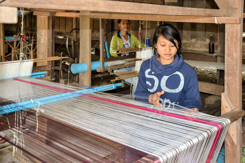 Im Seidenzentrum von Kambodscha arbeiten zwei Frauen an traditionellen Webtechniken