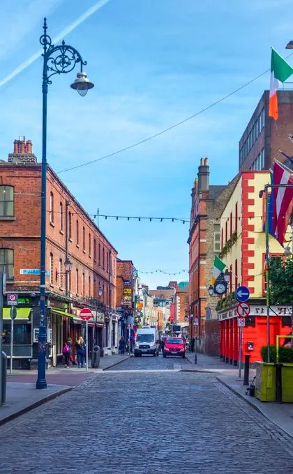 Gasse mit Kopfsteinpflastern und bunten Häusern in Dublin, Irland.