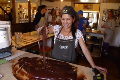 Eine Mitarbeiterin des Chocomuseums in Cusco Peru gießt Schokolade